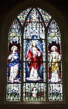 Stained glass window behind altar in Meelick church
